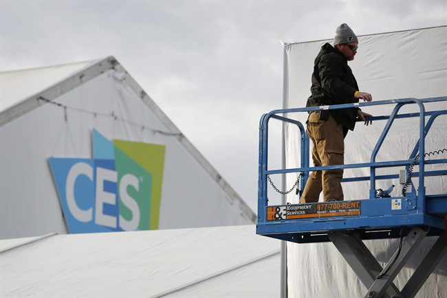 A worker helps prepare a temporary structure in preparation for the International CES gadget show Sunday, Jan. 3, 2016, in Las Vegas. The show officially kicks off Wednesday, Jan. 6. 