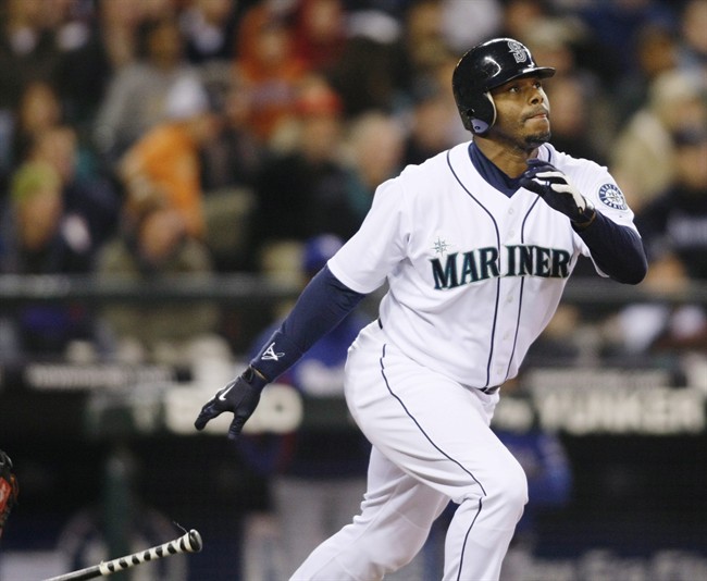 This is an Oct. 3, 2009, file photo showing Seattle Mariners' Ken Griffey Jr. hitting a solo home run on a pitch from Texas Rangers' Tommy Hunter during the fourth inning of a baseball game in Seattle.
