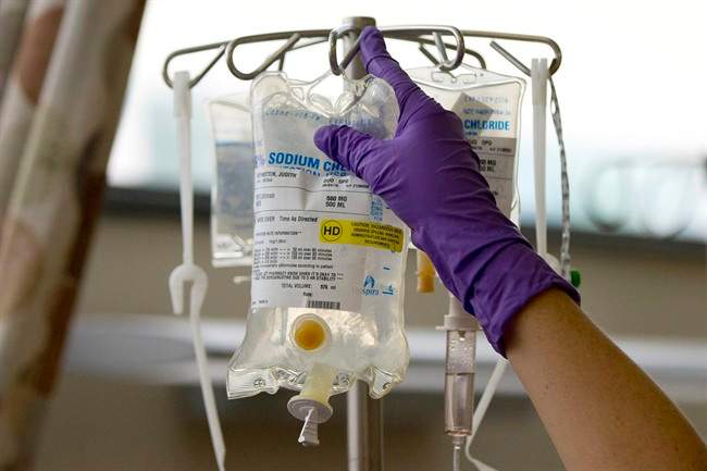 In this Tuesday, Aug. 4, 2015 file photo, a nurse places a patient's chemotherapy medication on an intravenous stand at a hospital in Philadelphia.