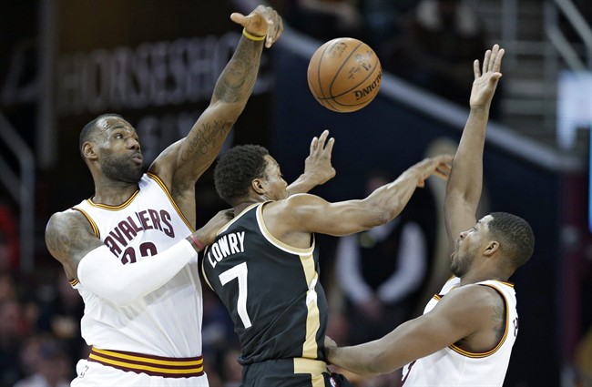 Cleveland Cavaliers' LeBron James, left, and Cleveland Cavaliers' Tristan Thompson, right, from Canada, put pressure on Toronto Raptors' Kyle Lowry in the first half of an NBA basketball game, Monday, Jan. 4, 2016, in Cleveland.
