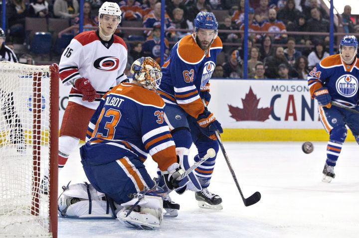 Carolina Hurricanes' Andrej Nestrasil (15) and Edmonton Oilers' Eric Gryba (62) look for the rebound from goalie Cam Talbot (33) during first period NHL action in Edmonton, Alta., on Monday January 4, 2016. 