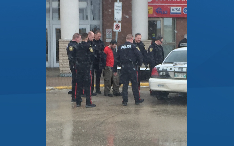 Photo of Winnipeg police arresting man after incident at Polo Park shopping centre. 