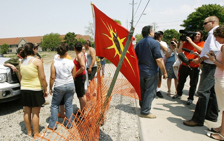 Garry Sault, middle, talks with the media after questioning Six Nations protesters as they guard the front entrance of a housing development in Hagersville, Ont., just south of the 15-month aboriginal occupation at Caledonia on Wednesday, May 23, 2007. The Ontario Provincial Police have agreed to follow guidelines when impersonating members of the media.