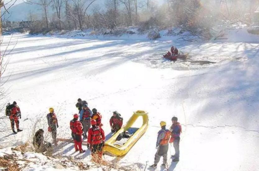 Rescue crews working to recover the body of a man who fell through the ice near Grand Forks on December 30.