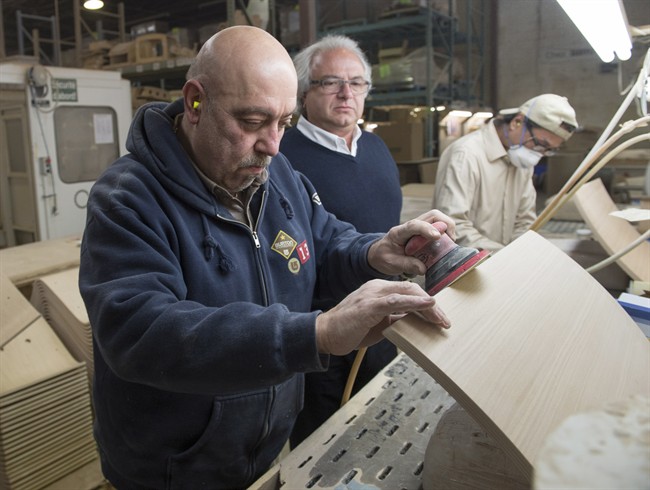 Garouj Nazarian, left, a Syrian refugee, works at Seatuply as owner Levon Aseyan looks on, Monday, January 18, 2016 in Montreal. The plywood company employs and helps integrate refugees from around the world.THE CANADIAN PRESS/Ryan Remiorz.