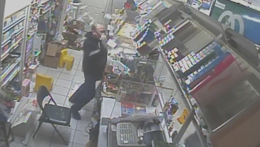 Caught on camera: store clerk wards off armed robber with crowbar - image