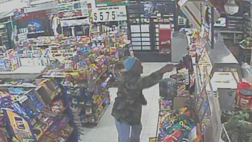 Caught on camera: store clerk wards off armed robber with crowbar - image