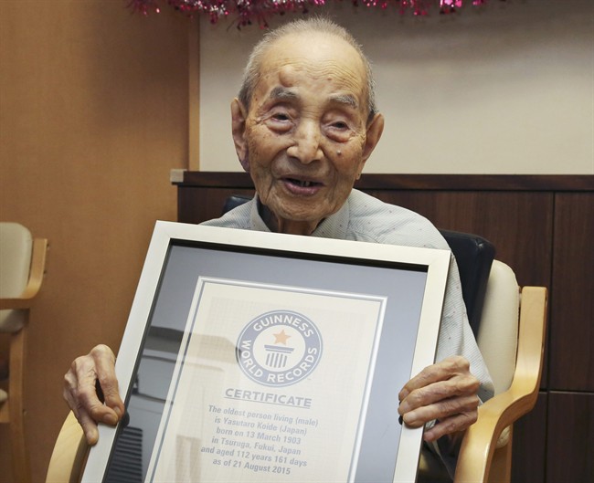 FILE - In this Aug. 21, 2015, file photo, Yasutaro Koide, 112, holds the Guinness World Records certificate as he is formally recognized as the world's oldest man at a nursing home in Nagoya, central Japan. Koide, who was born on March 13, 1903, has died on Tuesday, Jan. 19, 2016, two months short of his 113th birthday. (AP Photo/Koji Sasahara, FIle).