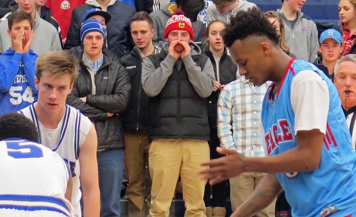 In this Jan. 12, 2016,  photo, fans cheer for their team, Whitefish Bay, during a high school basketball game against Milwaukee Morse-Marshall in Whitefish Bay, Wis. The director of a Wisconsin high school athletics association has apologized to administrators around the state for the distraction generated by an email urging them to prevent fans from taunting opponents with chants that some consider harmless -- yelling air ball or seasons over, for example.