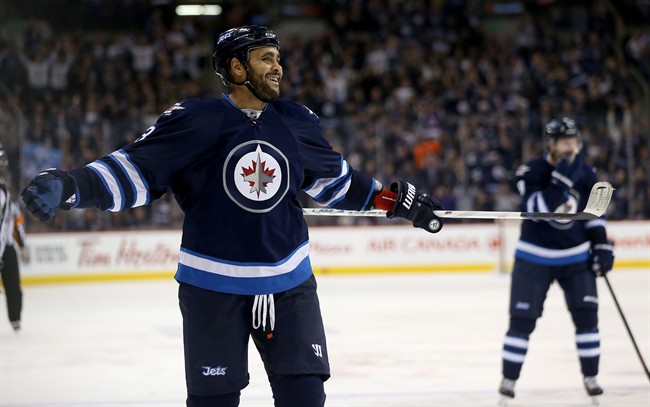 Winnipeg Jets' Dustin Byfuglien (33) laughs after scoring from just inside centre ice against the Arizona Coyotes during second period NHL hockey action, in Winnipeg, Tuesday, January 26, 2016.