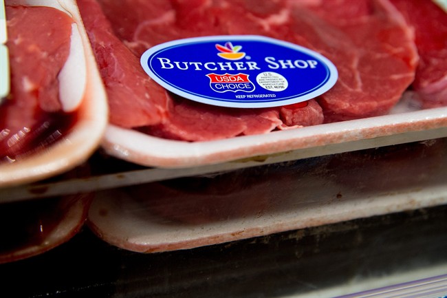 In this photo taken May 19, 2015, meat labels are seen at a grocery store in Washington. 