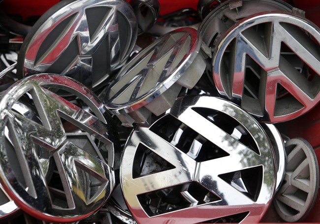In this Sept. 23, 2015 file photo Volkswagen ornaments sit in a box in a scrap yard in Berlin, Germany. 