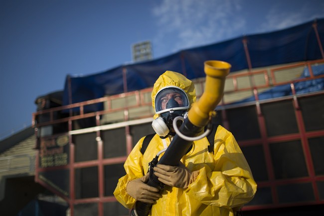 A health worker stands in the Sambadrome as he sprays insecticide to combat the Aedes aegypti mosquitoes that transmit the Zika virus, in Rio de Janeiro, Brazil, Jan. 26, 2016.