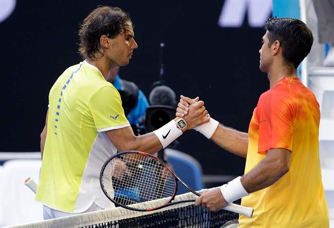 Rafael Nadal, left, of Spain congratulates compatriot Fernando Verdasco after their first round match at the Australian Open tennis championships in Melbourne, Australia, Tuesday, Jan. 19, 2016.(AP Photo/Aaron Favila).