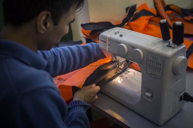 Afghan tailor Yasin Samadi , 27, works with a sewing machine in Pikpa Camp near the port of Mytilene on the northeastern Greek island of Lesbos.