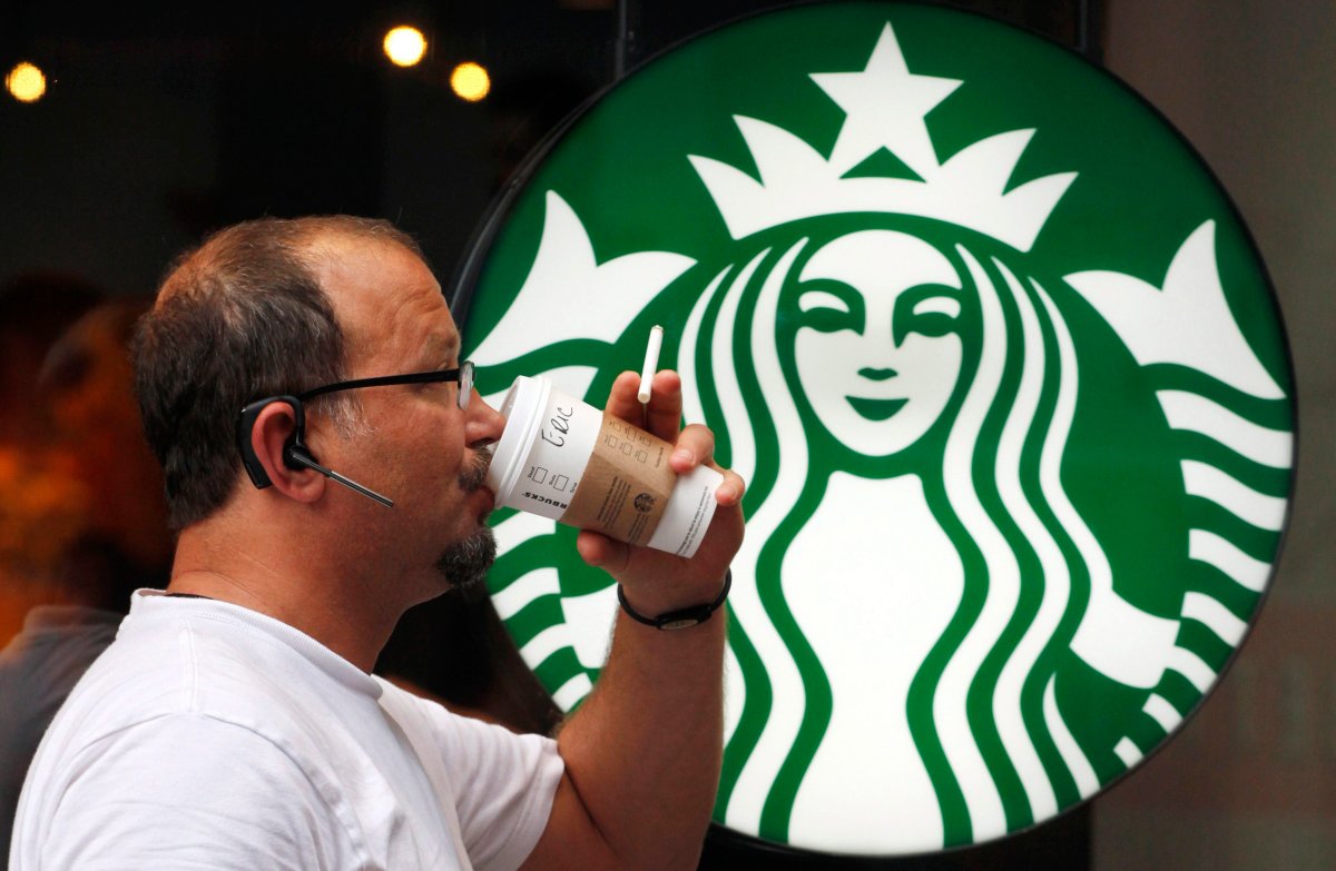 A man drinks a Starbucks beverage in New York. 