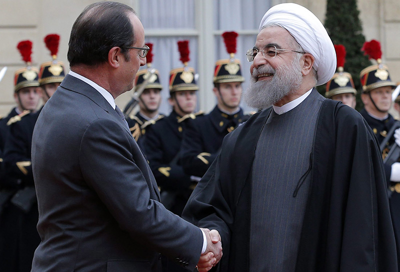 French president Francois Hollande, left,  greets Iranian President Hassan Rouhani before a meeting at the Elysee Palace, in Paris, Thursday, Jan. 28, 2016. 