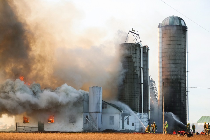 Firefighters battle a barn fire near St. Thomas, Ont. Monday, February 1, 2016.Ontario Provincial Police said approximately 90 dairy cows died Monday morning in a barn fire in Elgin County, in southwestern Ontario.