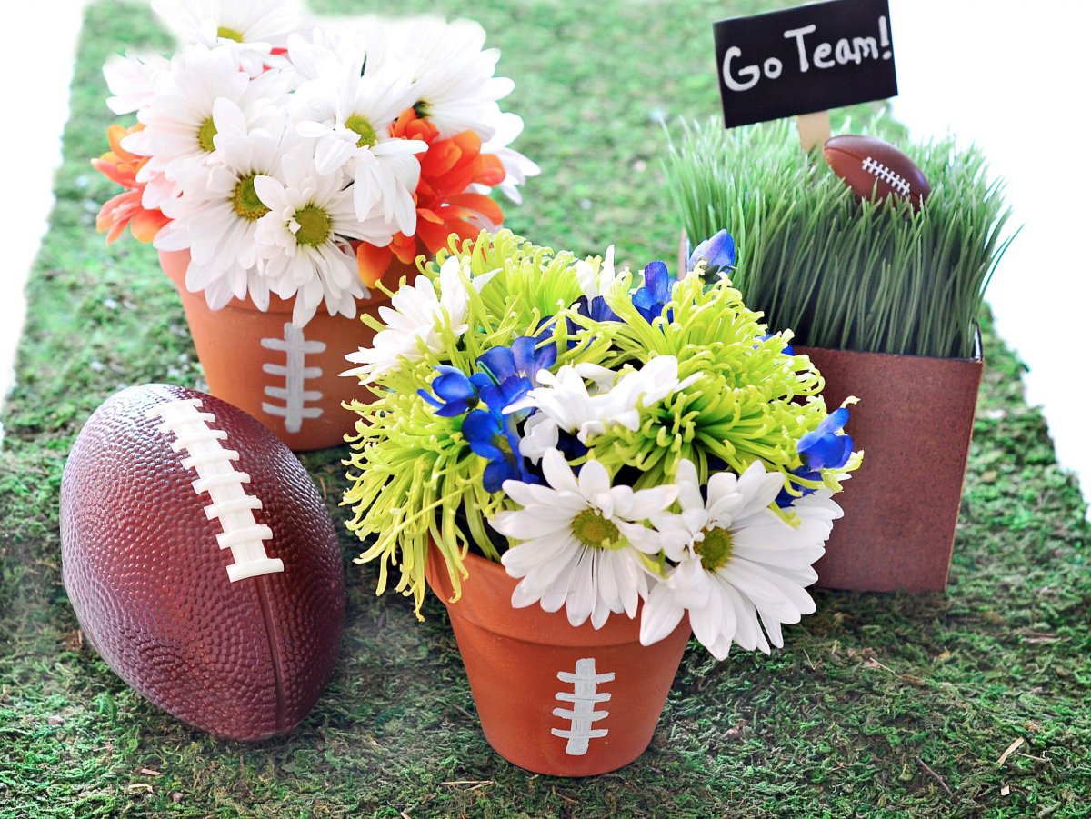 In this photo provided by HGTV, punch up the Super Bowl party fun with a few handmade decorations, including a centerpiece crafted from inexpensive clay pots painted with white "football laces" lines and filled with grocery-store flowers. It makes a great graphic impact, but its really inexpensive and its something you can put together in 30 minutes, says Marianne Canada, a designer for HGTV.com who hosts its Crafternoon series. 