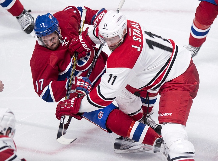 Montreal Canadiens' Torrey Mitchell is checked by Carolina Hurricanes' Jordan Staal during second period NHL hockey action Sunday, February 7, 2016 in Montreal. 
