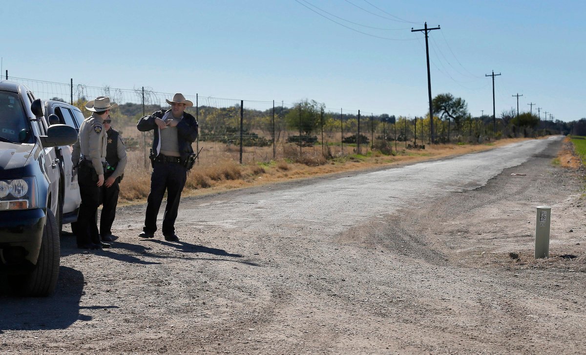 Uvalde County Sheriffs Deputies guard the intersection to a neighborhood several miles outside of Uvalde, Texas on Feb. 6, 2016. 