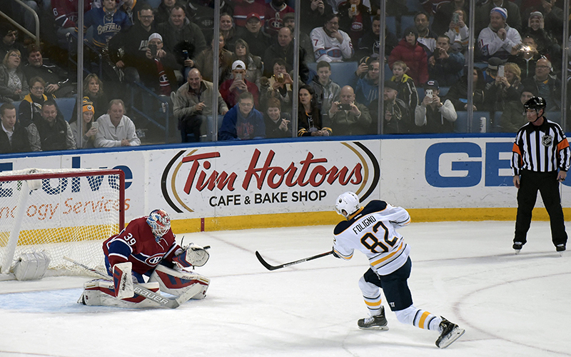 Buffalo Sabres' Marcus Foligno scores on a penalty shot over the glove of Montreal Canadiens' Mike Condon during the second period of an NHL hockey game, Friday, Feb. 12, 2016, in Buffalo, N.Y. 