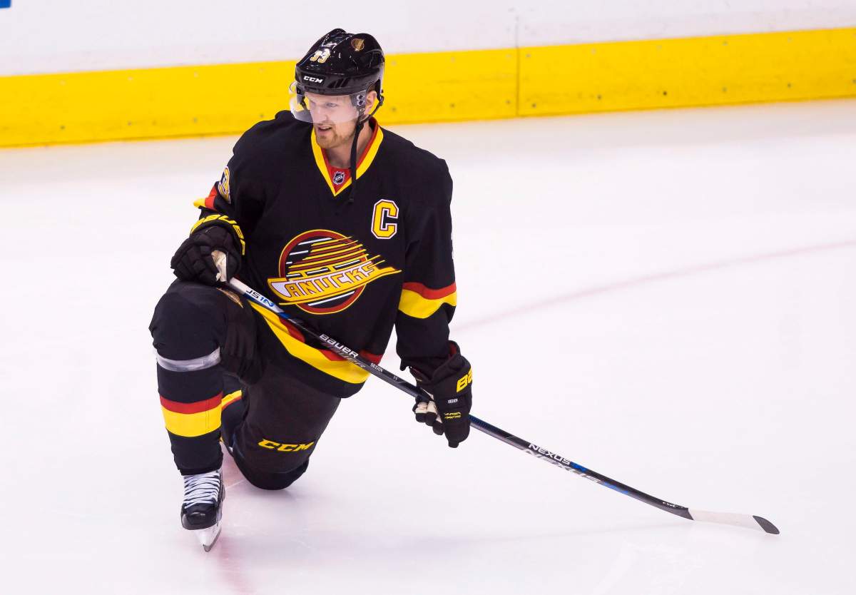 Vancouver Canucks’ Henrik Sedin stretches in warm-ups wearing the team’s flying skate uniform prior to facing the Toronto Maple Leafs in NHL hockey action in Vancouver, B.C., on Saturday February 13, 2016. THE CANADIAN PRESS/Ben Nelms