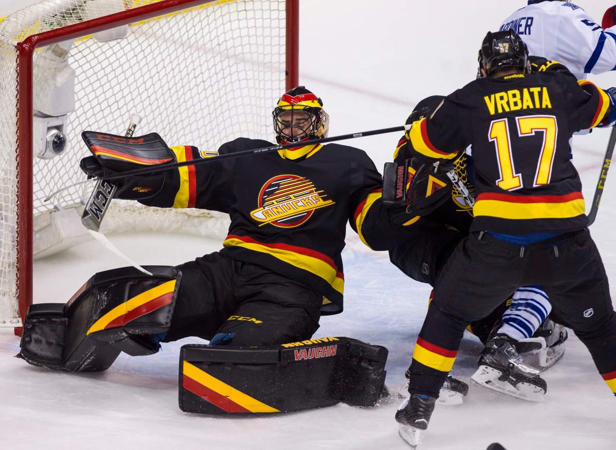 Vancouver Canucks goaltender Ryan Miller falls during second period NHL hockey action against the Toronto Maple Leafs in Vancouver, B.C., on Saturday February 13, 2016. Maple Leafs' Mark Arcobello, not shown, would score on the play. 