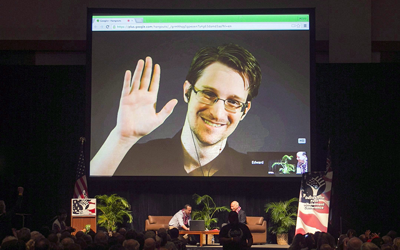 Edward Snowden appears on a live video feed broadcast from Moscow at an event sponsored by ACLU Hawaii in Honolulu on Feb. 14, 2015. 