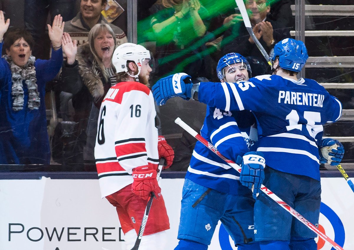 Toronto Maple Leafs right wing P.A. Parenteau (15) celebrates his goal with Maple Leafs centre Nazem Kadri (43) as Carolina Hurricanes centre Elias Lindholm (16) skates by during third period NHL hockey action in Toronto on Thursday, February 25, 2016.