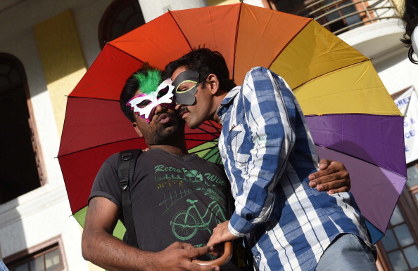 Indian gay rights activists belonging to the Karnataka Sexual Minorities Forum (KSMF) pose affectionately during a protest to demand the repeal of IPC 377 in Bangalore on July 2, 2014.
