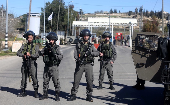 Israeli soldiers take security measures at the Beit El check point after they shot dead a Palestinian who allegedly opened fire at them in Ramallah, West Bank on January 31, 2016.  (Photo by Issam Rimawi/Anadolu Agency/Getty Images).