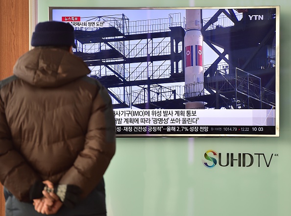 A man watches a news report on North Korea's planned rocket launch as the television screen shows file footage of North Korea's Unha-3 rocket which launched in 2012, at a railway station in Seoul on February 3, 2016. North Korea announced it planned to launch a space rocket between February 8-25, a move condemned by the United States as "another egregious violation" of UN resolutions following Pyongyang's nuclear test last month. 