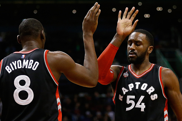 Patrick Patterson #54 of the Toronto Raptors high fives Bismack Biyombo #8 during the first half of the NBA game against the Phoenix Suns at Talking Stick Resort Arena on February 2, 2016 in Phoenix, Arizona.  (Photo by Christian Petersen/Getty Images).