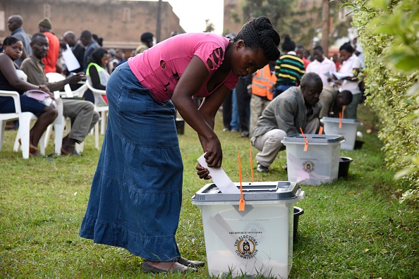 A woman casts her vote in presidential and parliamentary polls, on February 18, 2016 at the Nasuti polling station in Mukono District, some 23 kilometres east of the capital Kampala. 
Ugandans began voting on February 18 in presidential and parliamentary polls, with veteran leader Yoweri Museveni widely expected to extend his power into a fourth decade. 