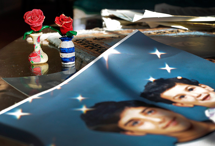 Prison artwork created by Adnan Syed sits near family photos in the home of his mother, Shamim Syed, in Baltimore.