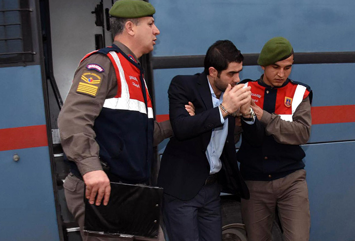 Prison guards escort Asem Alfrhad before his trial in Aegean resort of Bodrum, Turkey on Thursday Feb. 11, 2016. 