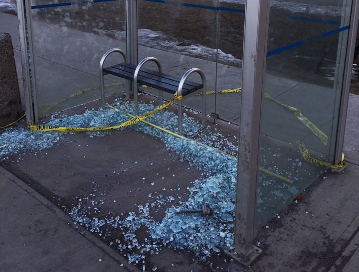 A bus shelter with its glass shattered on 50 Street.