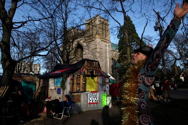 A camp resident celebrates at the homeless camp, also known as InTent City, during a block party at the camp in Victoria, B.C., Thursday, February 25, 2016. Supporters came over from Vancouver and Abbotsford during the planned soft eviction day. 