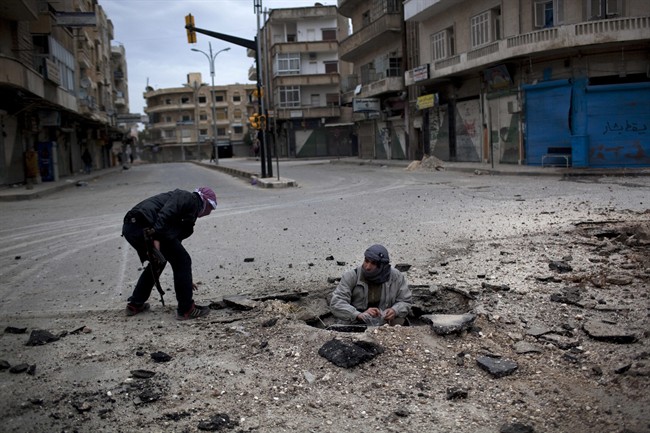  In this Sunday, March 11, 2012 file photo, Free Syrian Army fighters plant a roadside bomb to destroy a Syrian Army tank during a day of fierce fighting with the government forces in Idlib, north Syria.