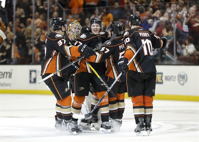 The Anaheim Ducks players celebrate their team's 2-1 overtime win against the Edmonton Oilers in an NHL hockey game Friday, Feb. 26, 2016, in Anaheim, Calif.