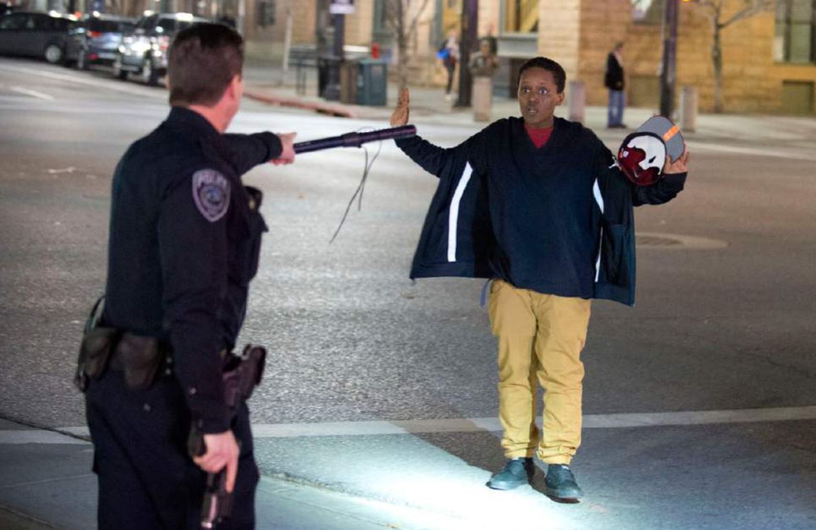 Police stop a boy as he walks away from a crowd that formed after an officer-involved shooting at 200 South Rio Grande Street in Salt Lake City, Saturday, Feb. 27, 2016. Unrest broke out in a Salt Lake City neighborhood on Saturday night after what appears to be a shooting involving a police officer, the Salt Lake Tribune reported. 