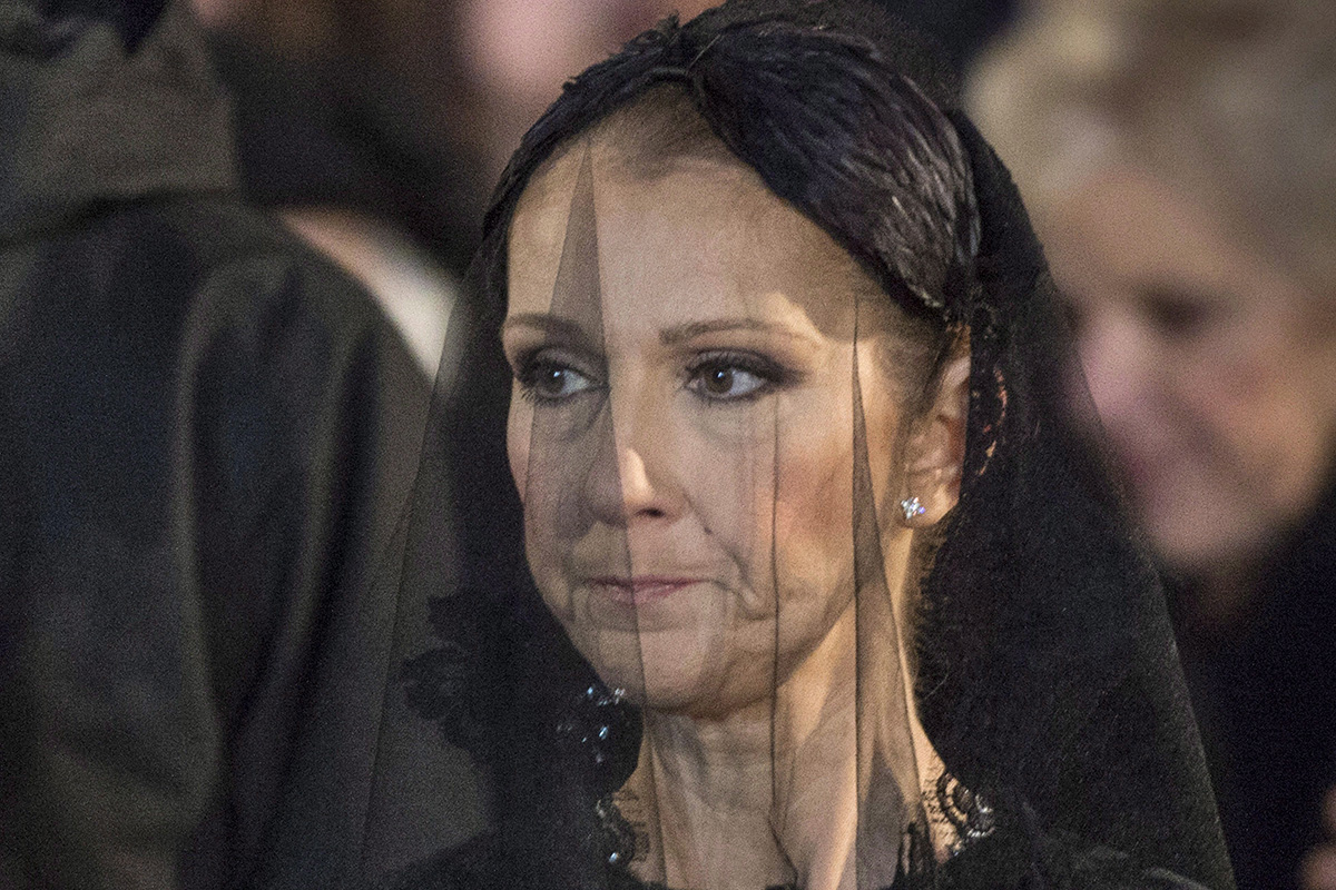 Celine Dion watches the casket of her late husband René Angélil's taken away following his funeral at Notre-Dame Basilica Friday, January 22, 2016 in Montreal.
