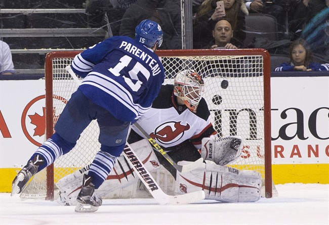 Toronto Maple Leafs Pierre-Alexandre Parenteau (15) scores on New Jersey Devils goaltender Keith Kinkaid during the shoot out in NHL hockey action in Toronto on Thursday February 4, 2016. THE CANADIAN PRESS/Chris Young.