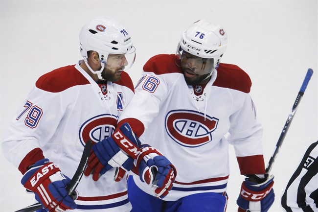 Montreal Canadiens defenseman Andrei Markov, left, of Russia, celebrates scoring a goal with defenseman P.K. Subban against the Colorado Avalanche in the first period go an NHL hockey game Wednesday, Feb. 17, 2016, in Denver.