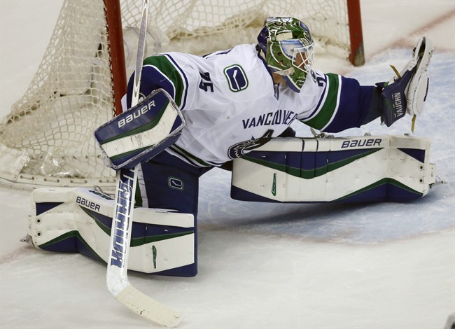 Vancouver Canucks goalie Jacob Markstrom, of wedeln, makes a glove save off a shot against the Colorado Avalanche in the first period of an NHL hockey game Tuesday, Feb. 9, 2016 in Denver. 