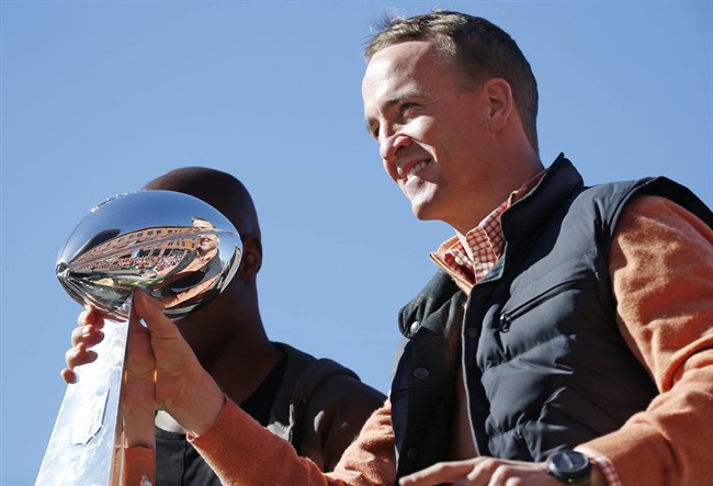 Denver Broncos quarterback Peyton Manning holds the Lombardi Trophy during a parade for the NFL football Super Bowl champions, Tuesday, Feb. 9, 2016, in Denver. 