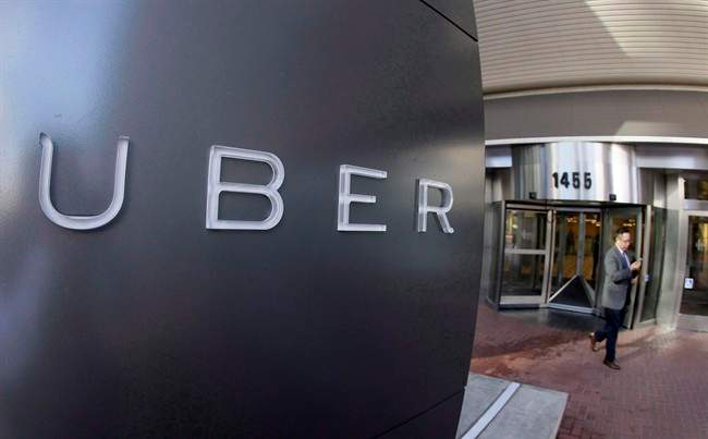 A man leaves the headquarters of Uber in San Francisco on Dec. 16, 2014.