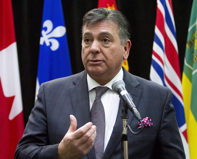 Ontario Finance Minister Charles Sousa talks to reporters before the start of a meeting with Federal Finance Minister Bill Morneau and his provincial and territorial counterparts, in Ottawa, on Monday, Dec. 21, 2015. Ontario's Liberal government will introduce the 2016 provincial budget on Feb. 25, two months earlier than last year's fiscal plan was announced.