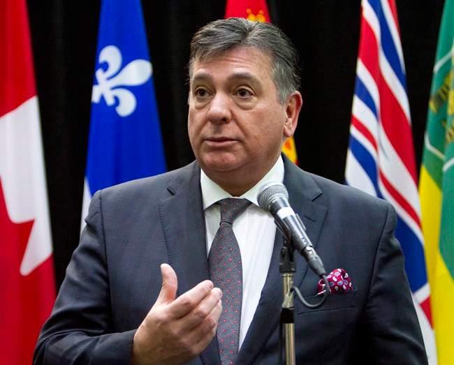 Ontario Finance Minister Charles Sousa talks to reporters before the start of a meeting with Federal Finance Minister Bill Morneau and his provincial and territorial counterparts, in Ottawa, on Monday, Dec. 21, 2015.